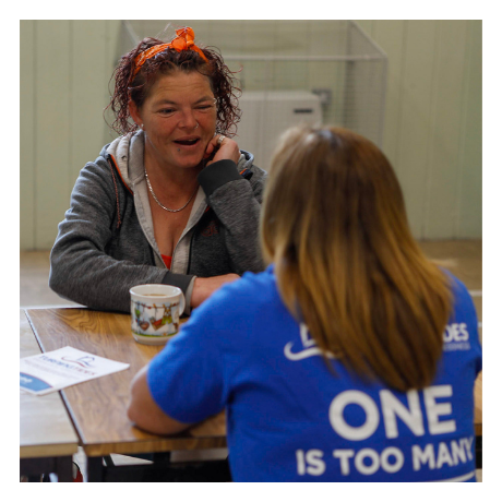 Client and frontline staff member chatting in hub